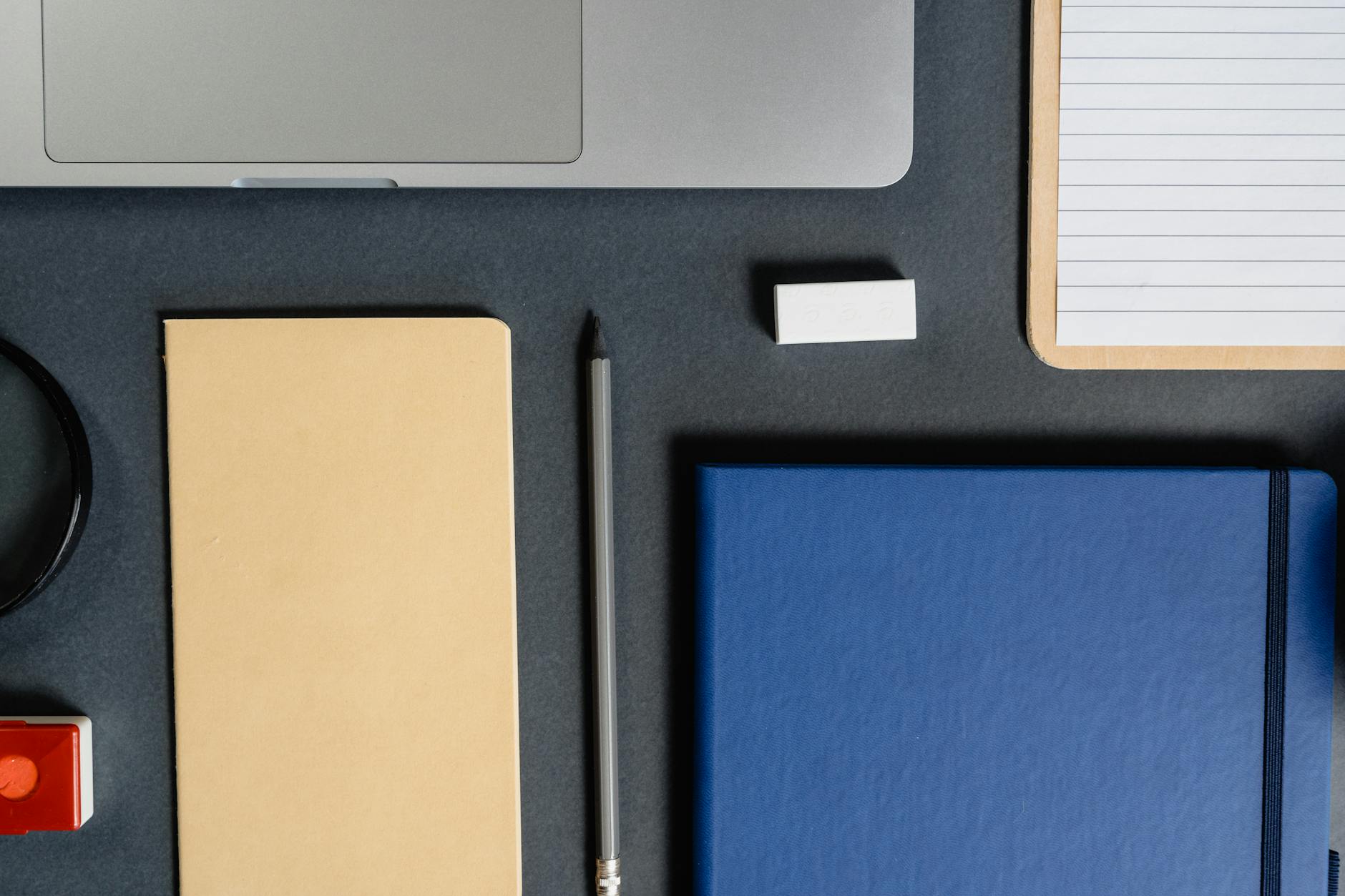 Speaker flatlay with notebooks and pen